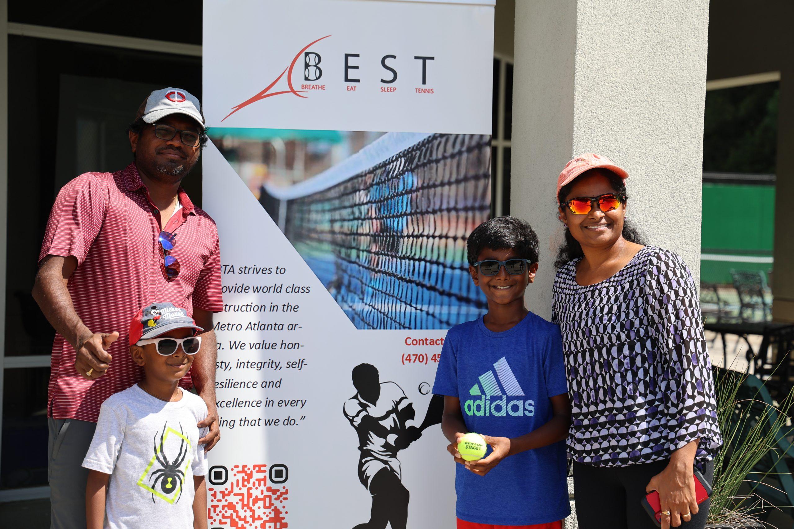BEST Tennis Academy family day with banner and players