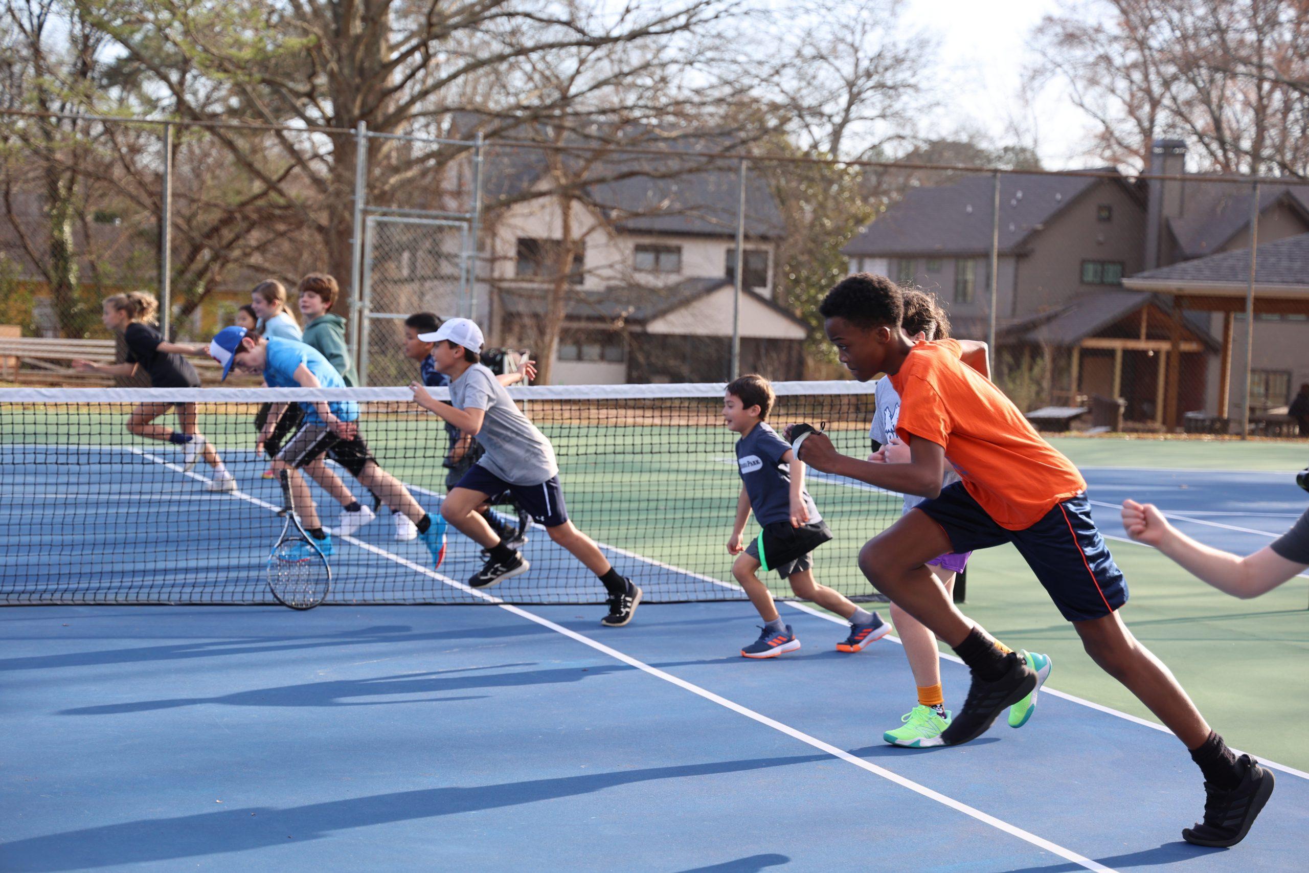 Junior tennis players during active on-court training at BEST Tennis Academy