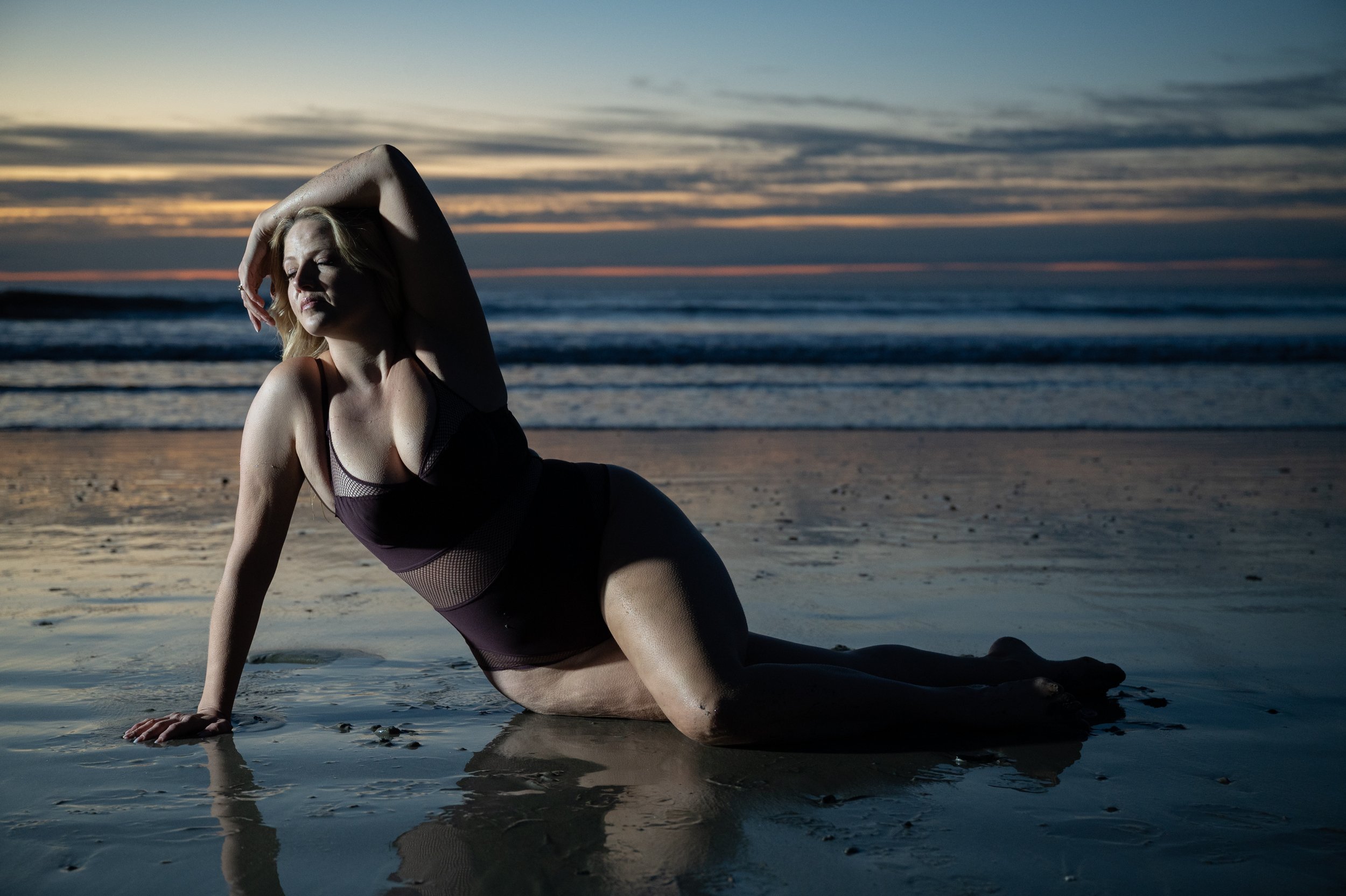Dramatic twilight beach portrait lying by the water