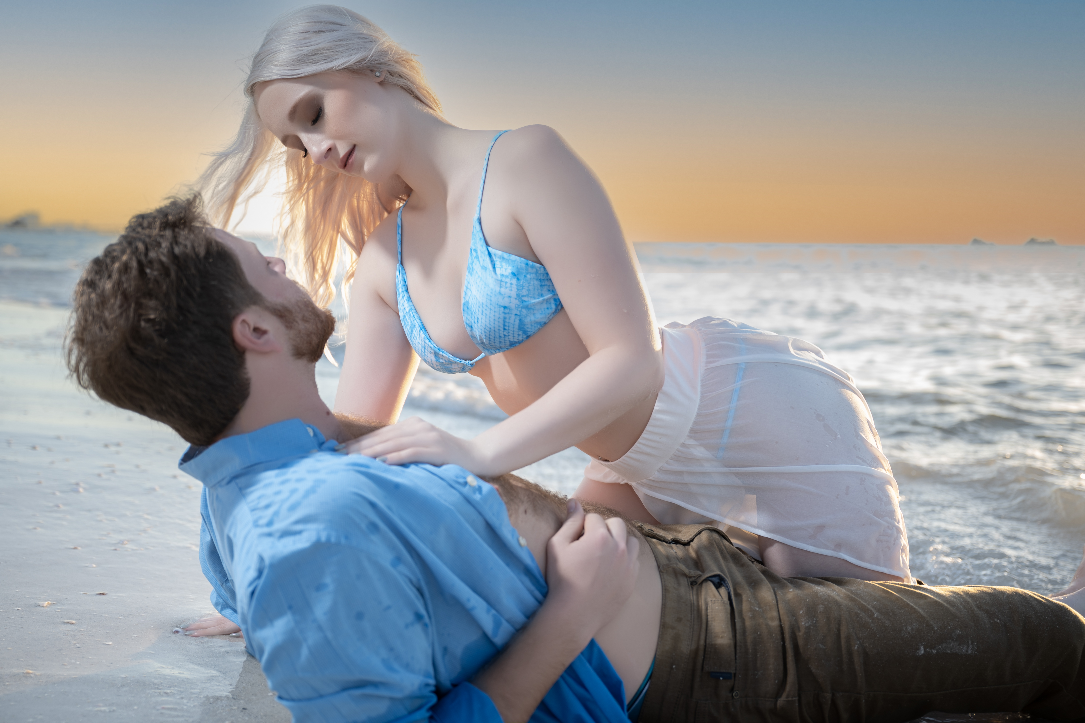 Intimate couple portrait embracing on sunlit beach