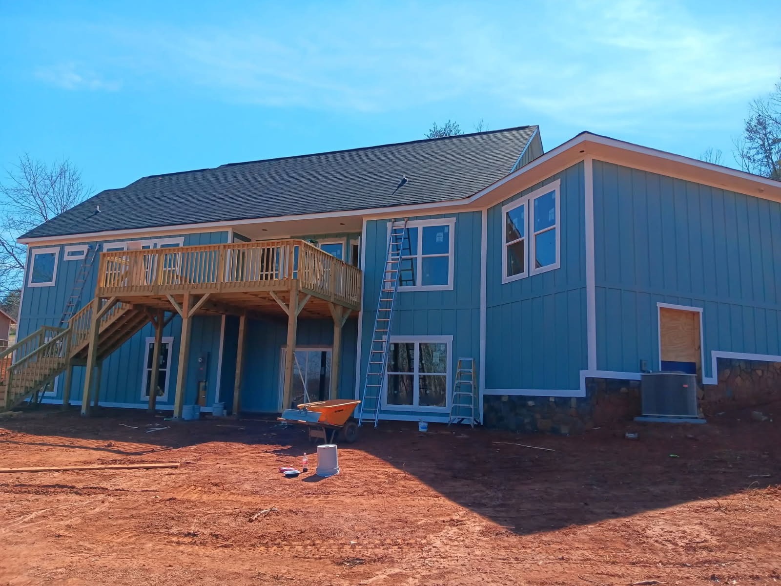 Two-Story Board & Batten Modern Teal Siding & Timber Deck
