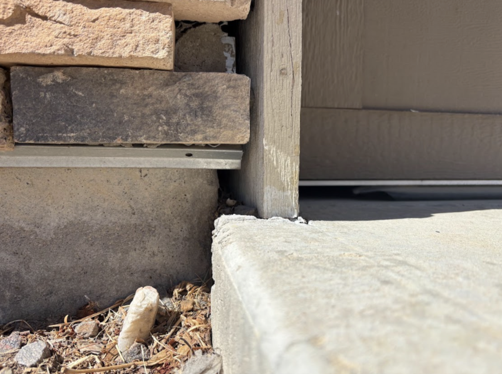 Garage Door & Foundation Corner - Before