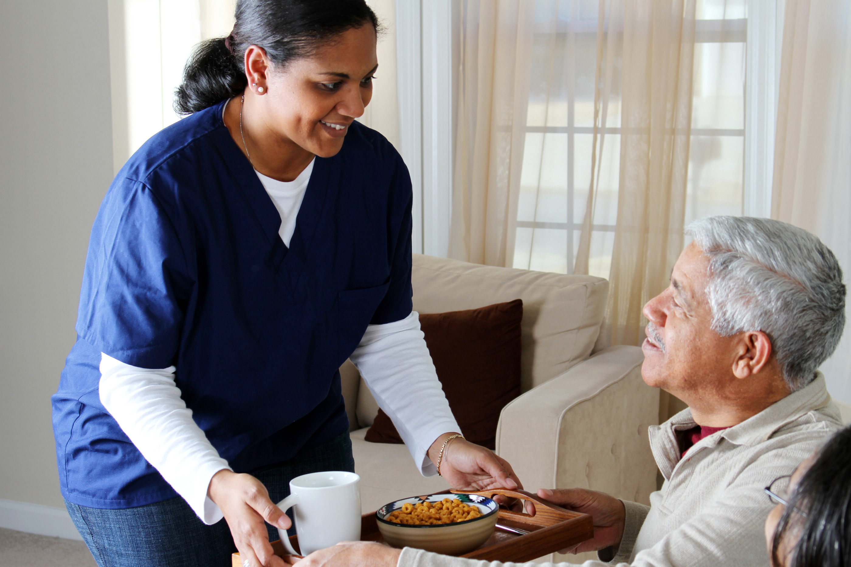 Compassionate healthcare professional caring for a resident at Baldwin Gardens Nursing Center