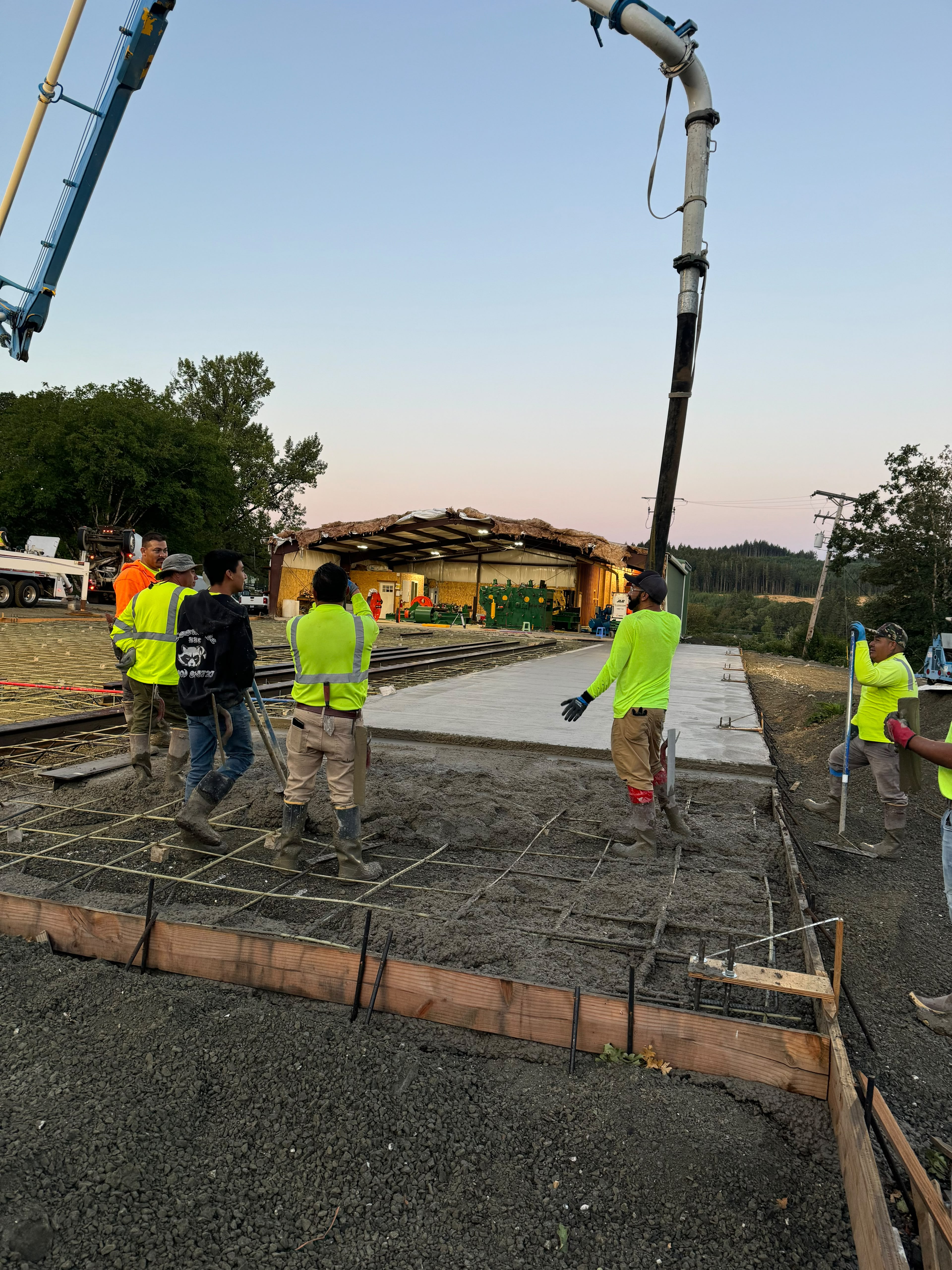 Foothills Concrete LLC crew using concrete boom pump truck for large foundation slab pour in Oregon