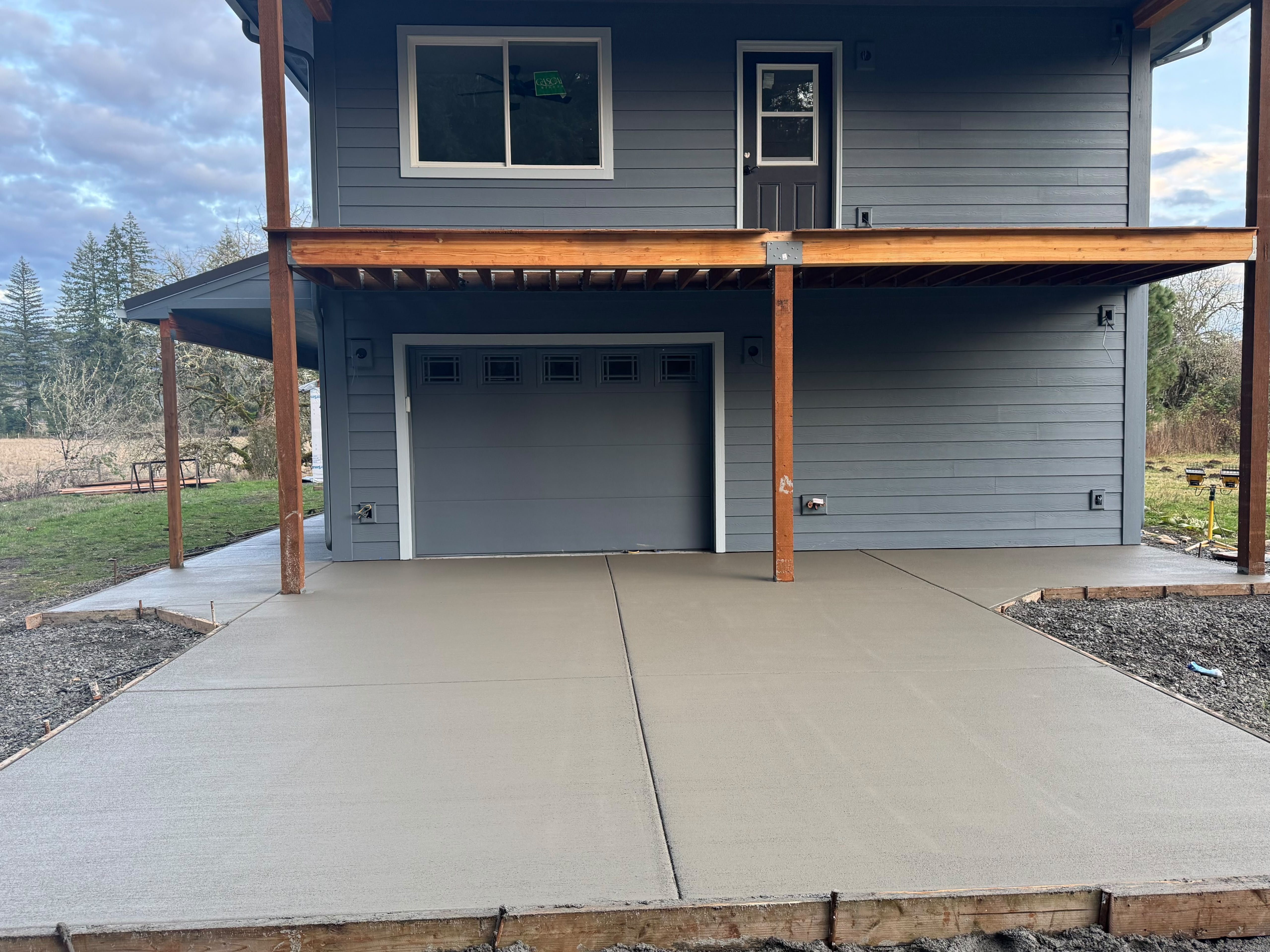 Smooth broom finish concrete driveway and parking apron installed by Foothills Concrete LLC in Salem OR