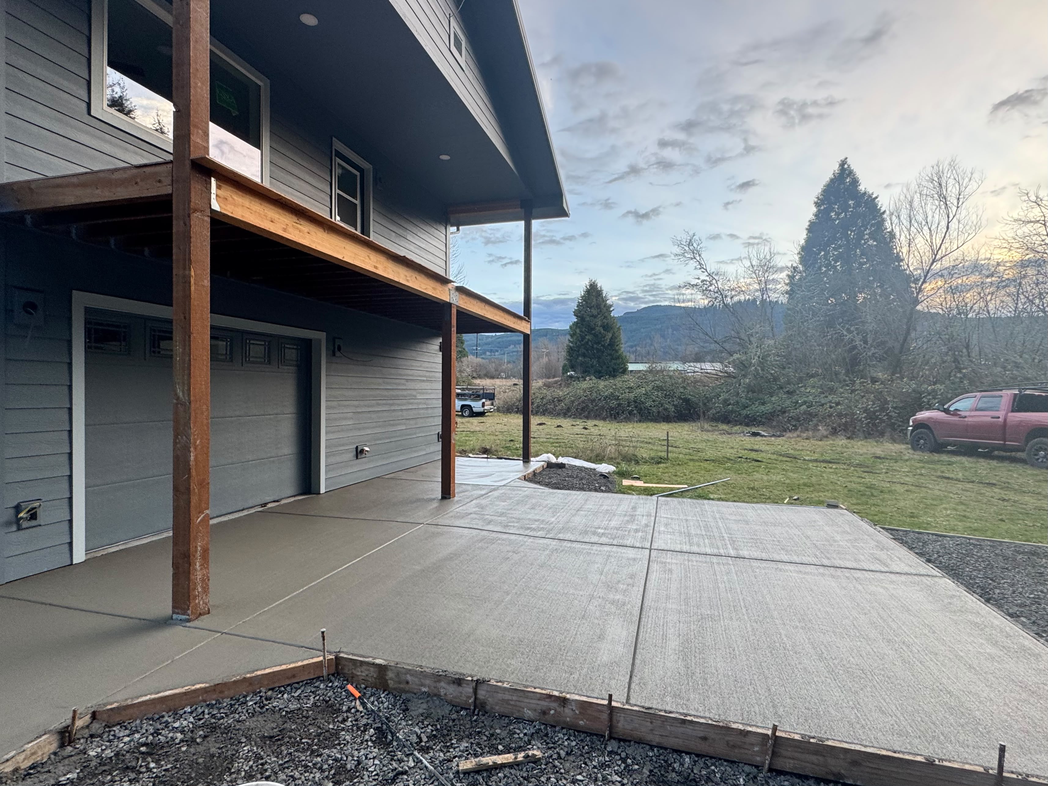 residential concrete lower patio under elevated deck and garage approach in Dallas Oregon by Foothills Concrete LLC