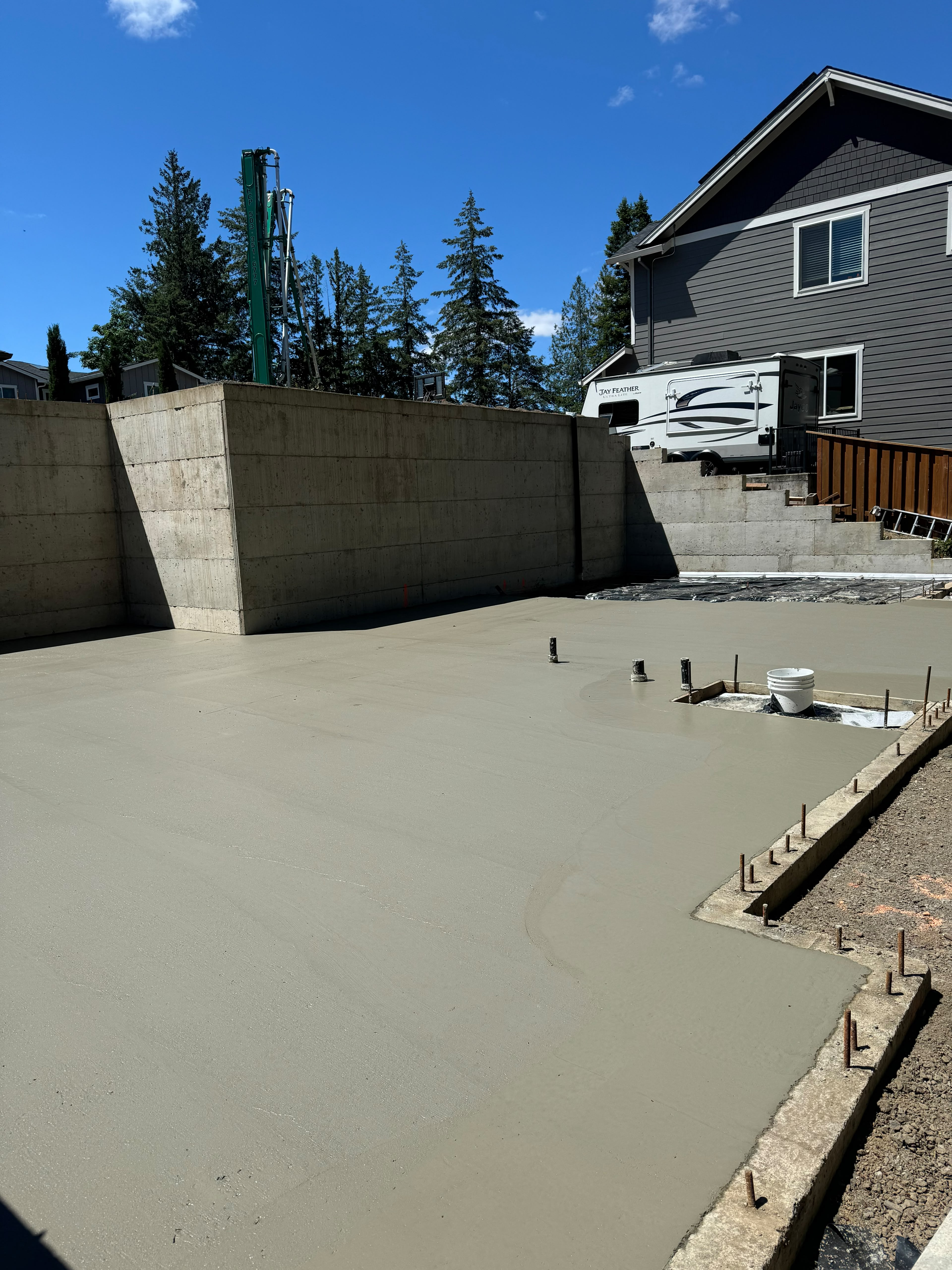 structural concrete home foundation slab and retaining wall pour with pump truck by Foothills Concrete LLC in Oregon