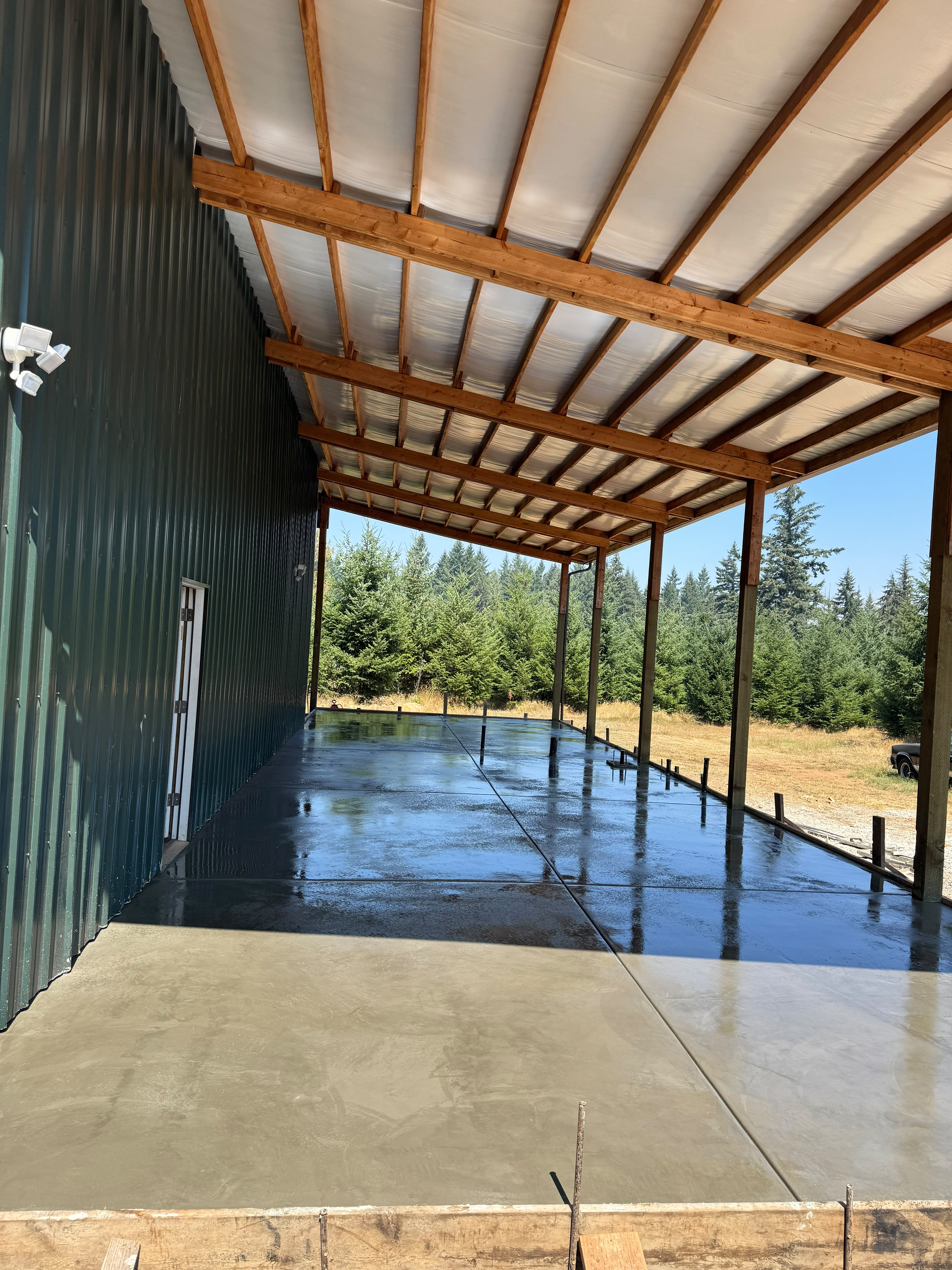 covered timber pole building concrete equipment pad and smooth cured floor slab in Salem Oregon by Foothills Concrete LLC