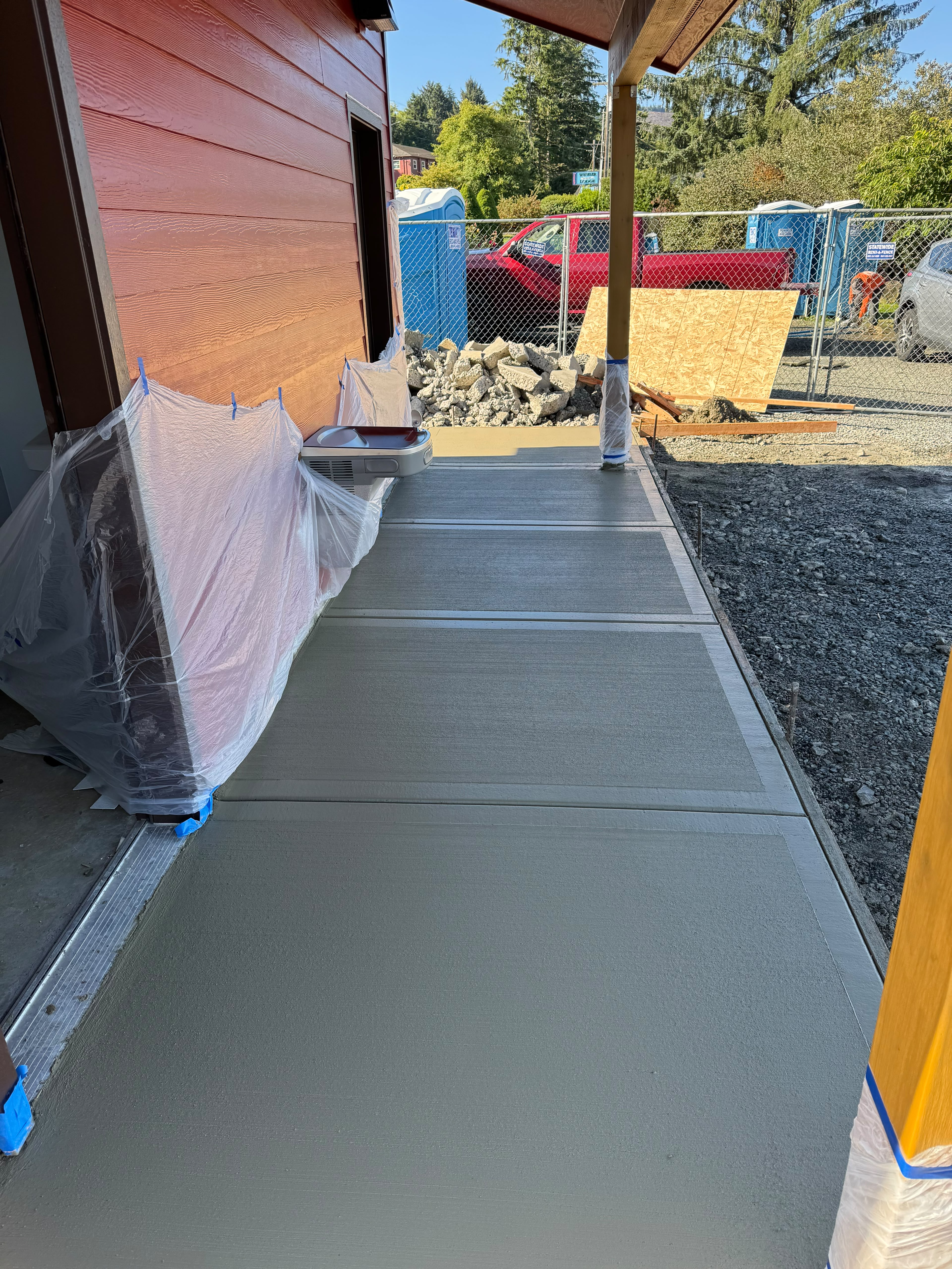 commercial covered building exterior walkway with hand-tooled borders and broom finish poured by Foothills Concrete LLC in Keizer OR