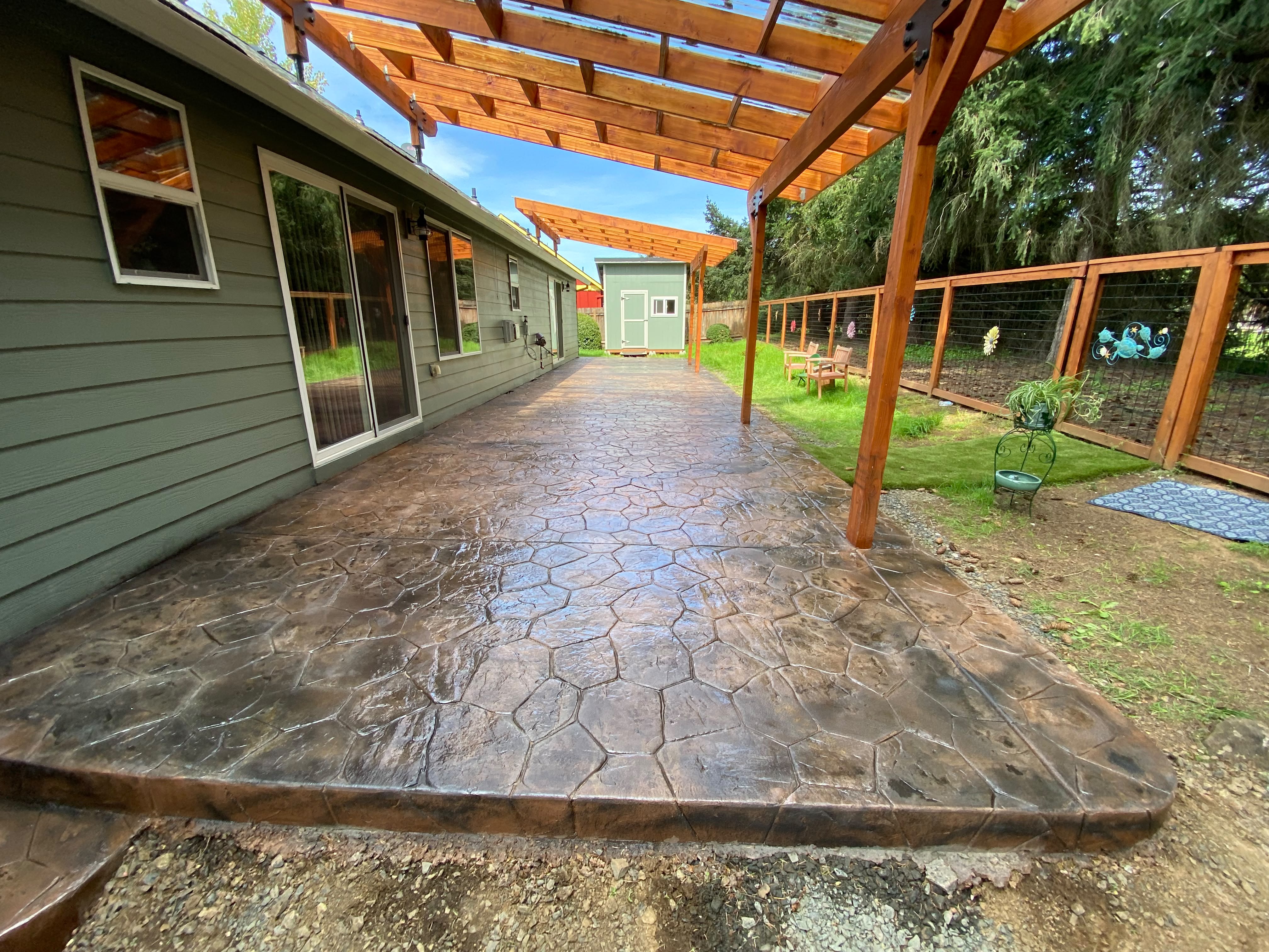 High-end stamped concrete patio in slate pattern with charcoal accent release by Foothills Concrete LLC