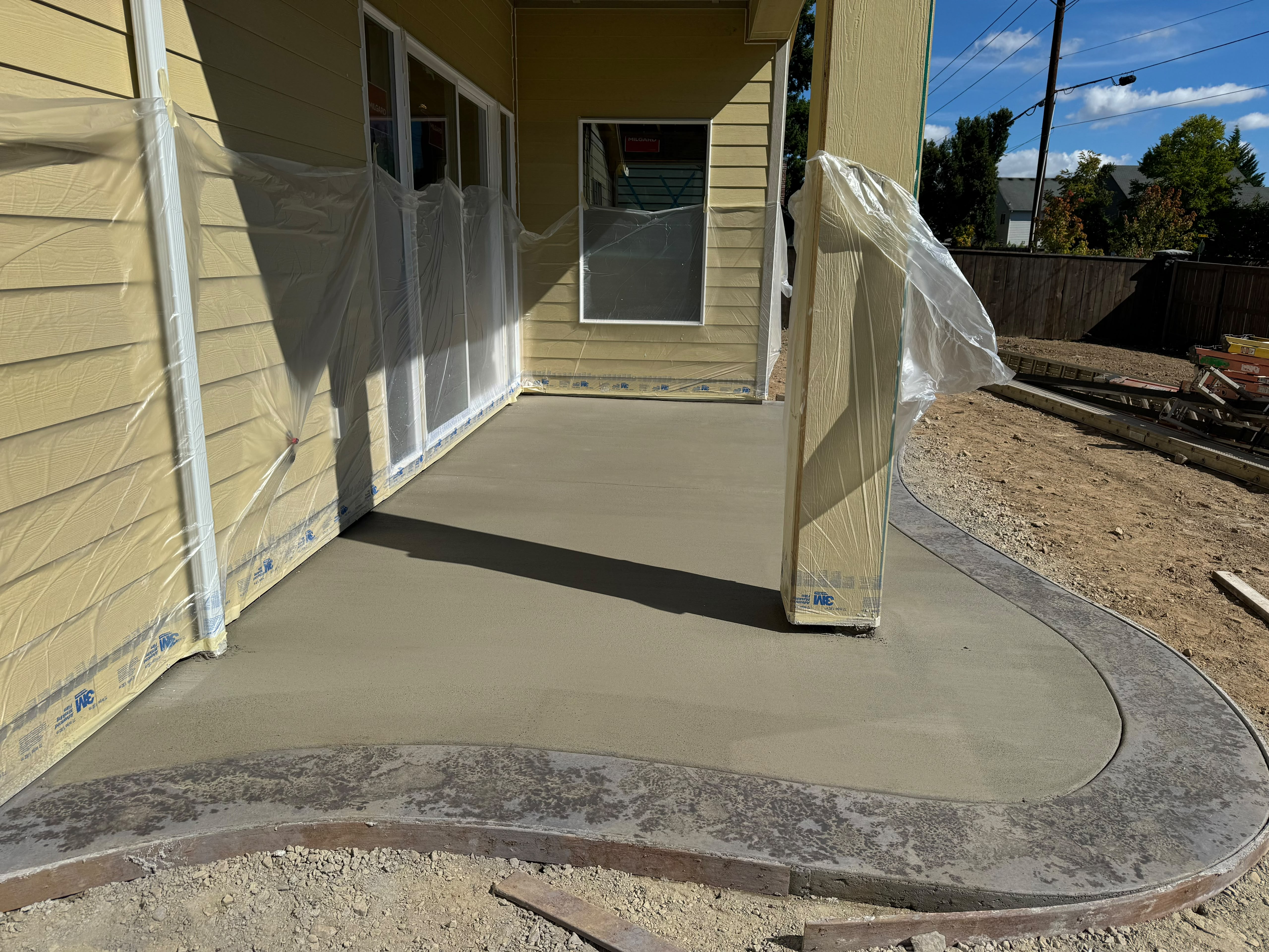 custom curved stamped concrete border accent on residential covered porch slab in Salem Oregon by Foothills Concrete LLC