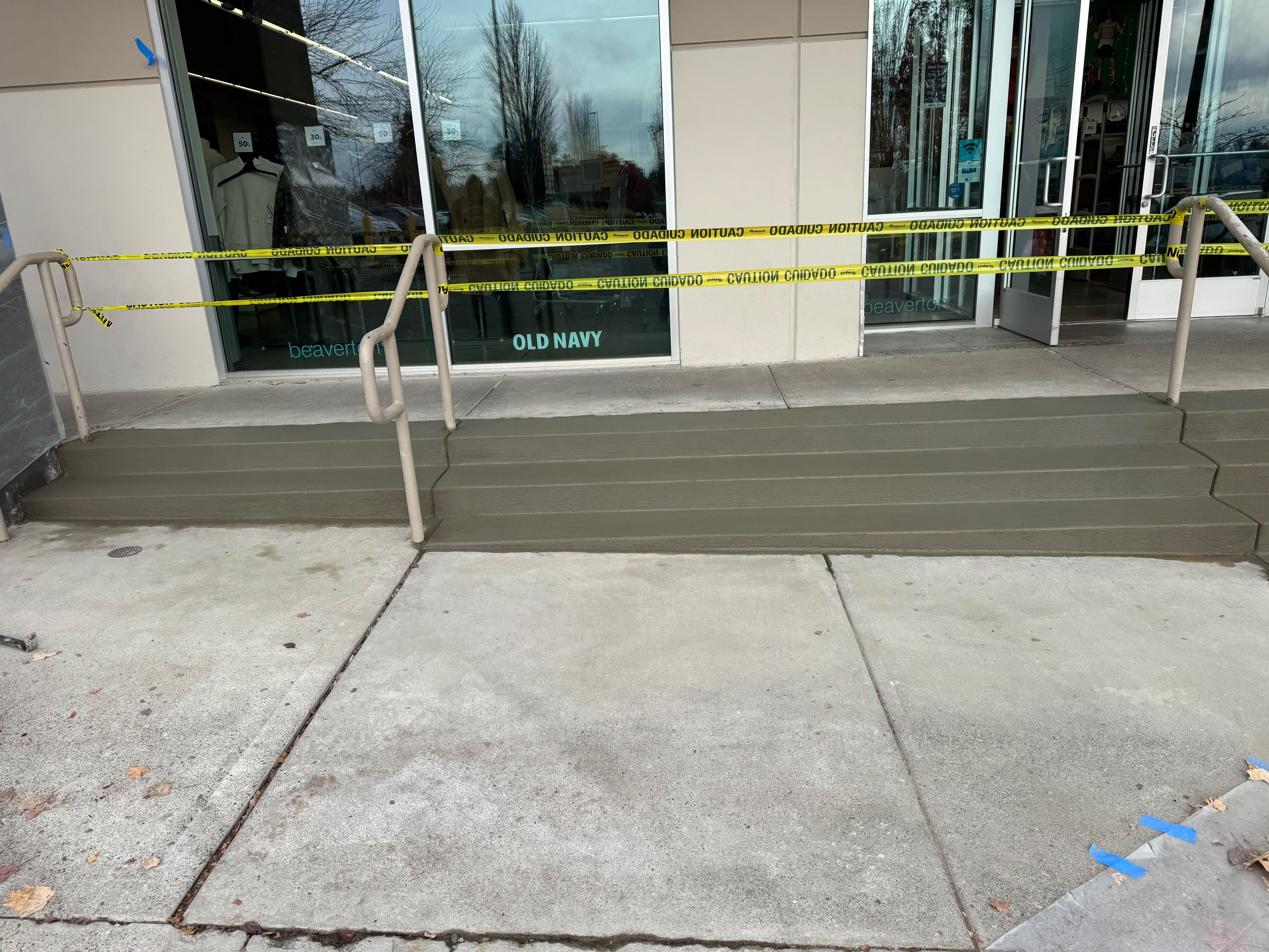 commercial storefront concrete entry steps and safety handrail installation in Beaverton OR by Foothills Concrete LLC