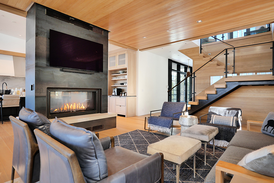 Refined modern living interior with fireplace and architectural oak staircase