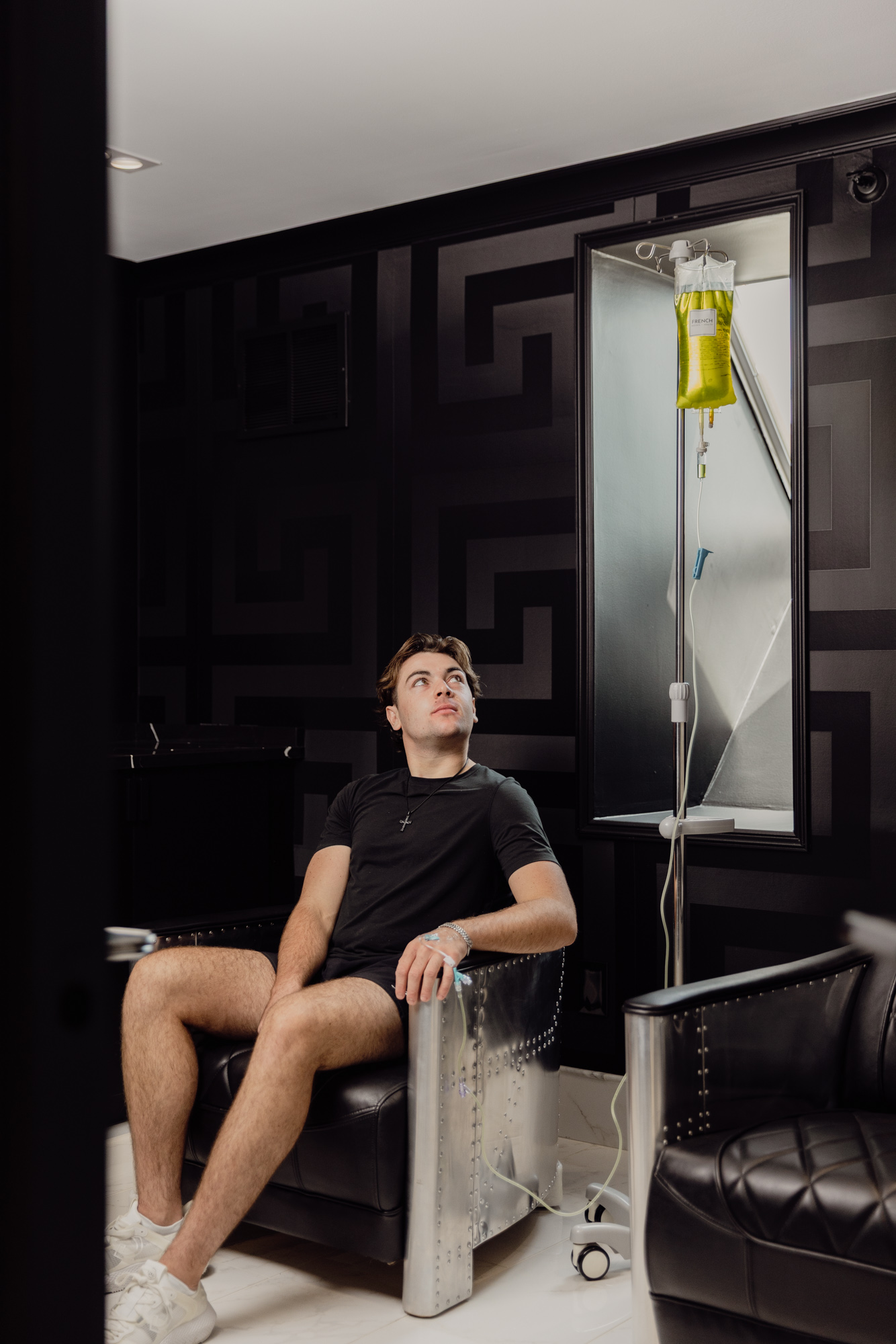 Client receiving IV infusion therapy in a private wellness suite