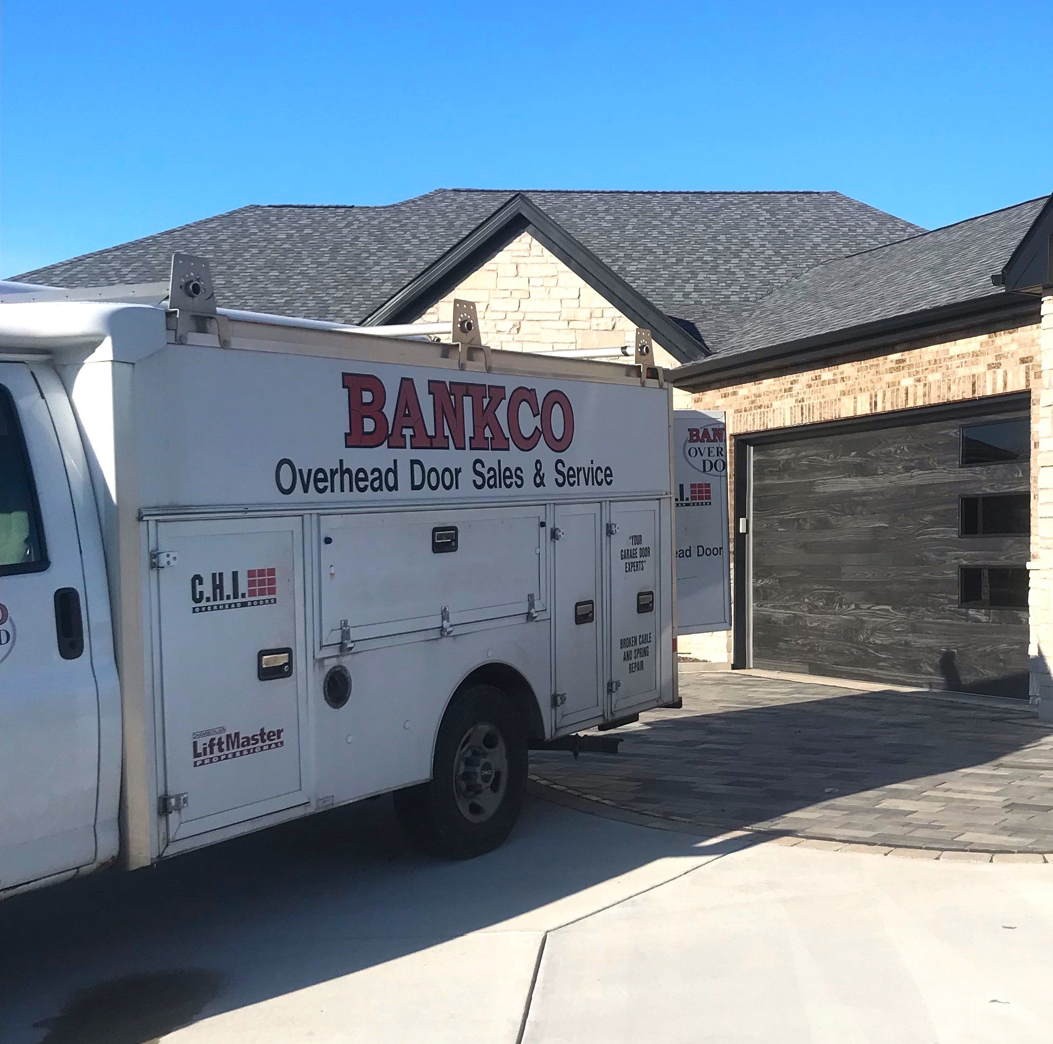 Bankco Overhead Door service truck at a residential garage door job