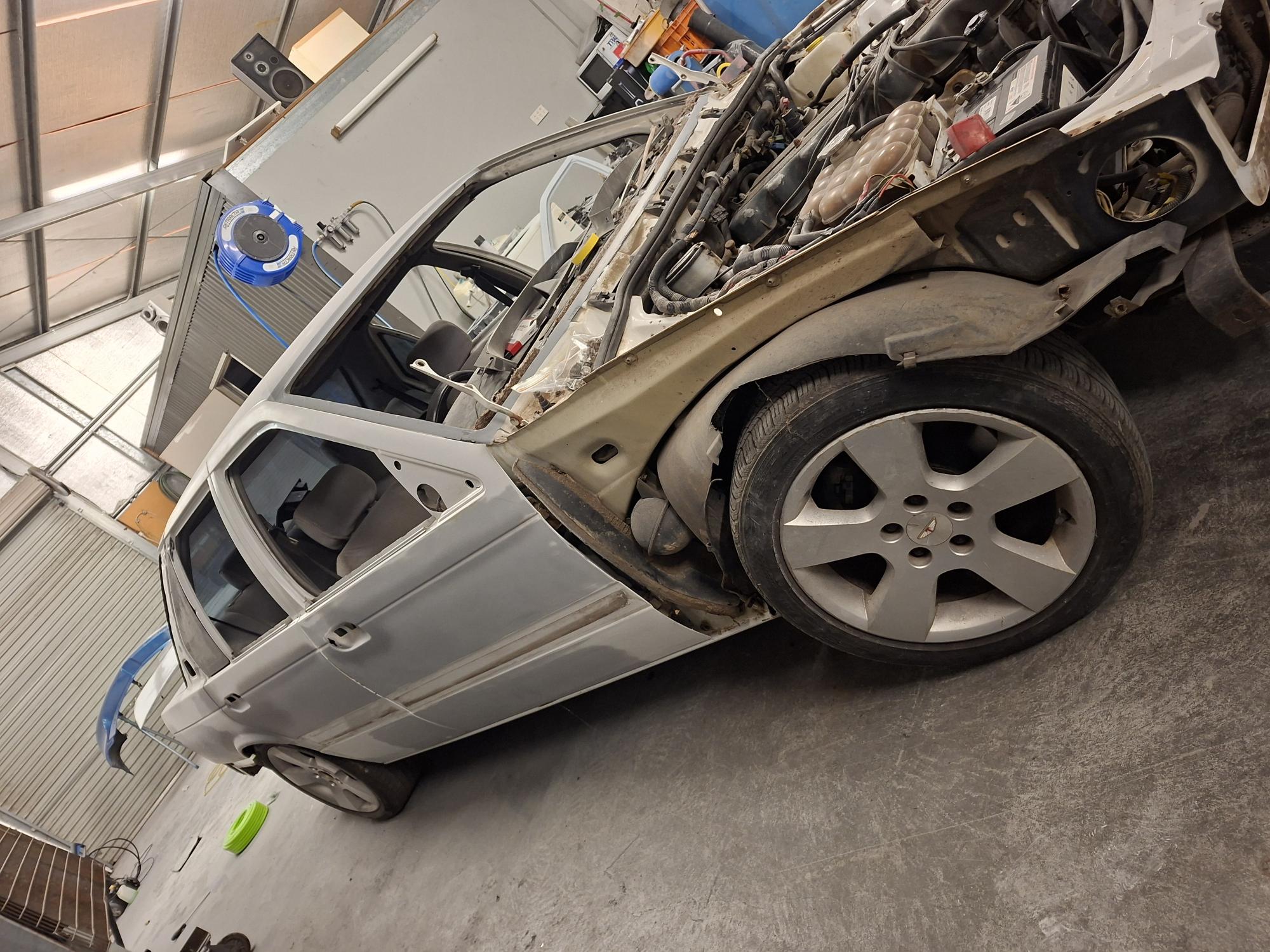 Stripped A-pillar, door hinge mounts and inner wheel arch during autobody rebuild and prep at D&T Autobody Horsham panel beating shop