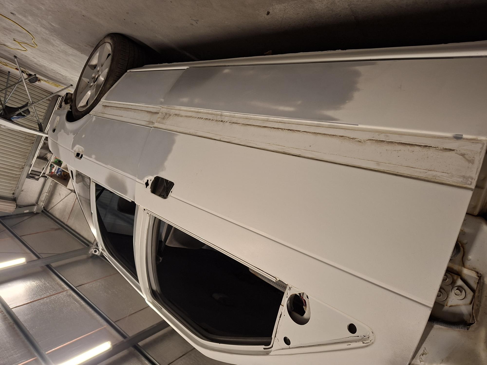 Lower door skins prepped, rubbed down and feather-edged for perfect flush alignment and respray at D&T Autobody Horsham workshop