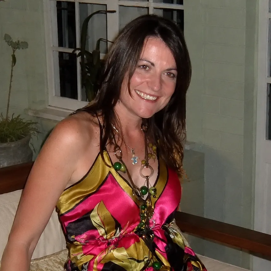 Lalena as an adult smiling in a vibrant silk dress during her career years