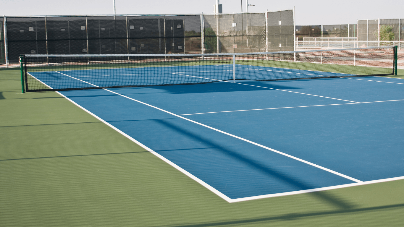 Overhead view of a blue and green tennis court with crisp white boundary lines during a court builder service in Henderson, NV