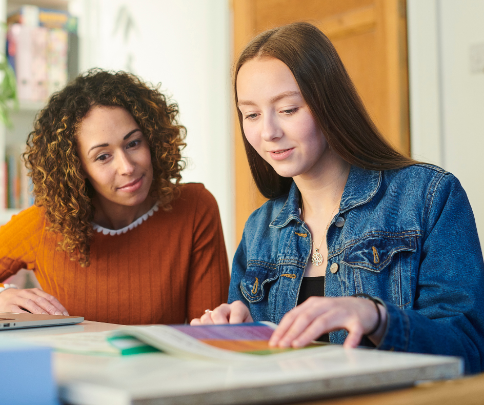 A tutor working one-on-one with a student at a table
