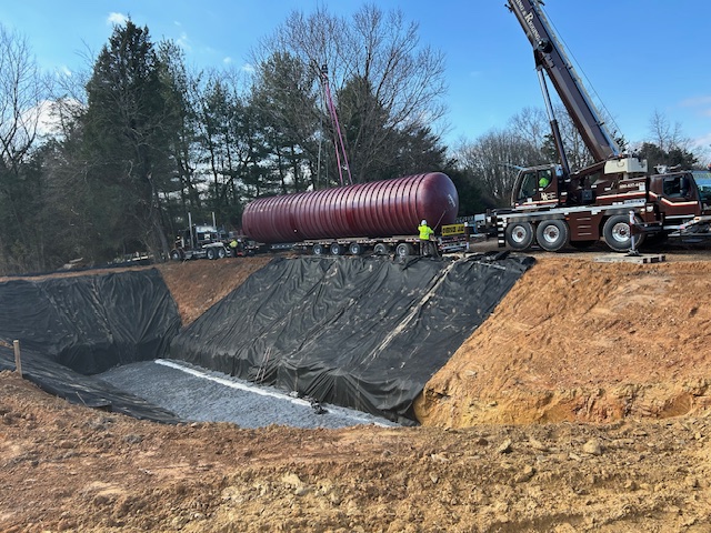 Stormwater retention tank installation and crane placement during site work