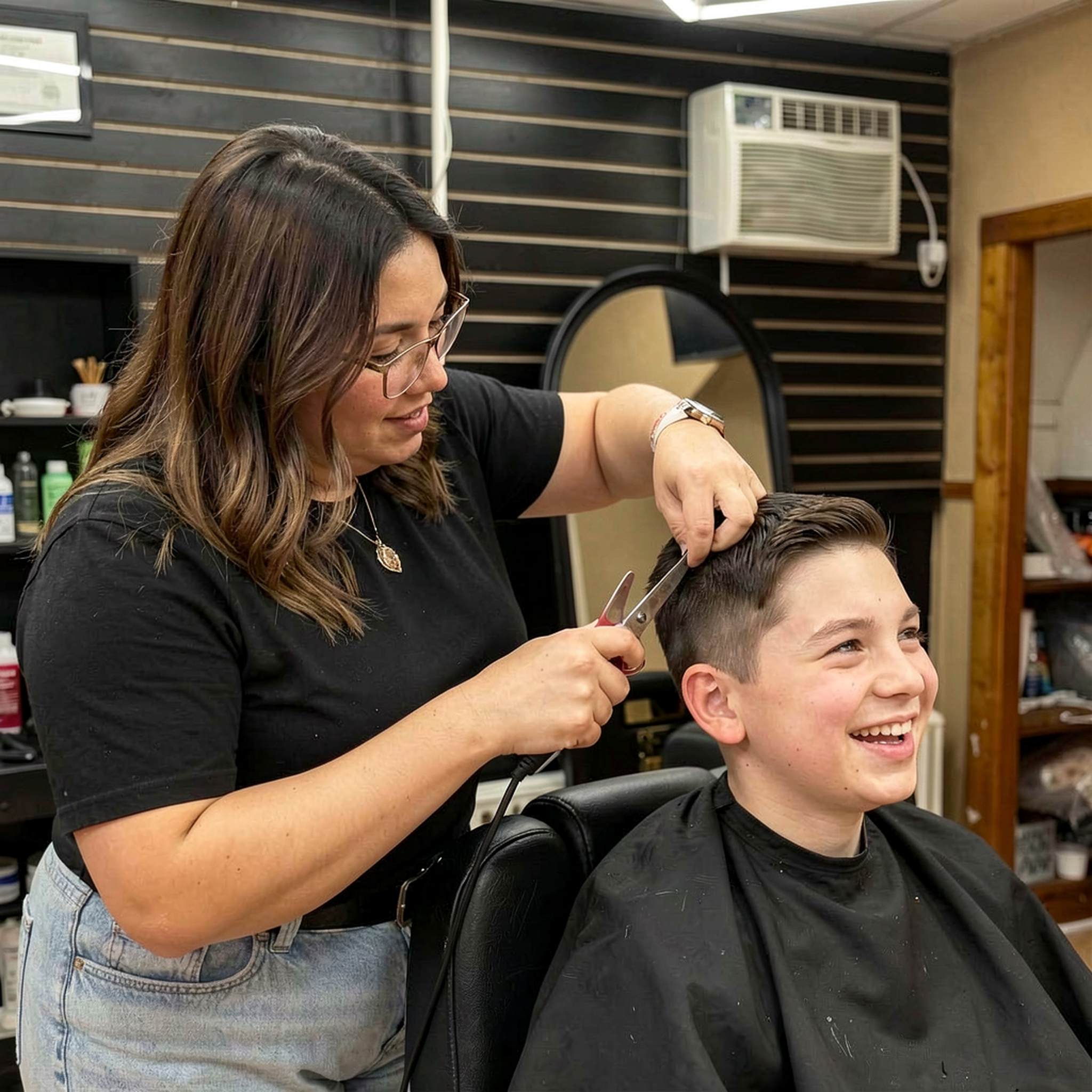 Dulce cutting hair with scissors at D&L Studio barbershop in Columbus, WI