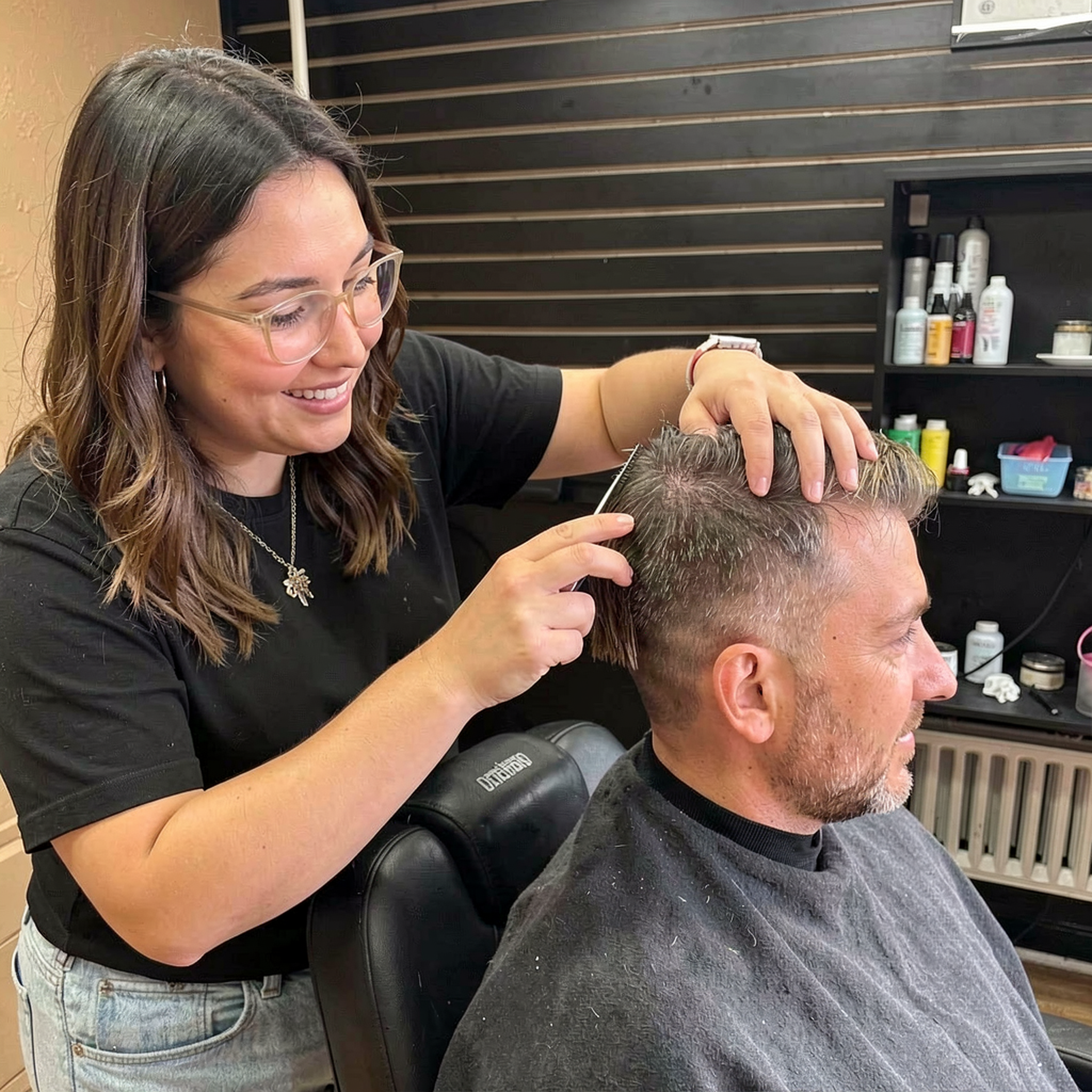 Dulce <Dool-Say>, owner of D&L Studio, focused on a precision haircut at her barbershop in Columbus, WI