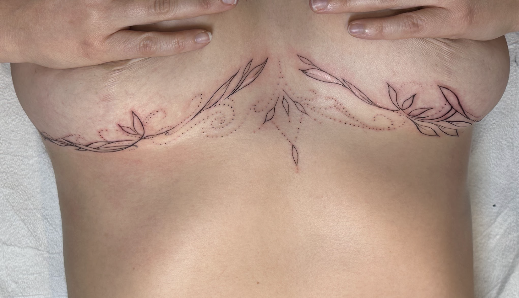 Sacred Symmetrical Underbust & Sternum Flourish Tattoo by Justine Almaraz