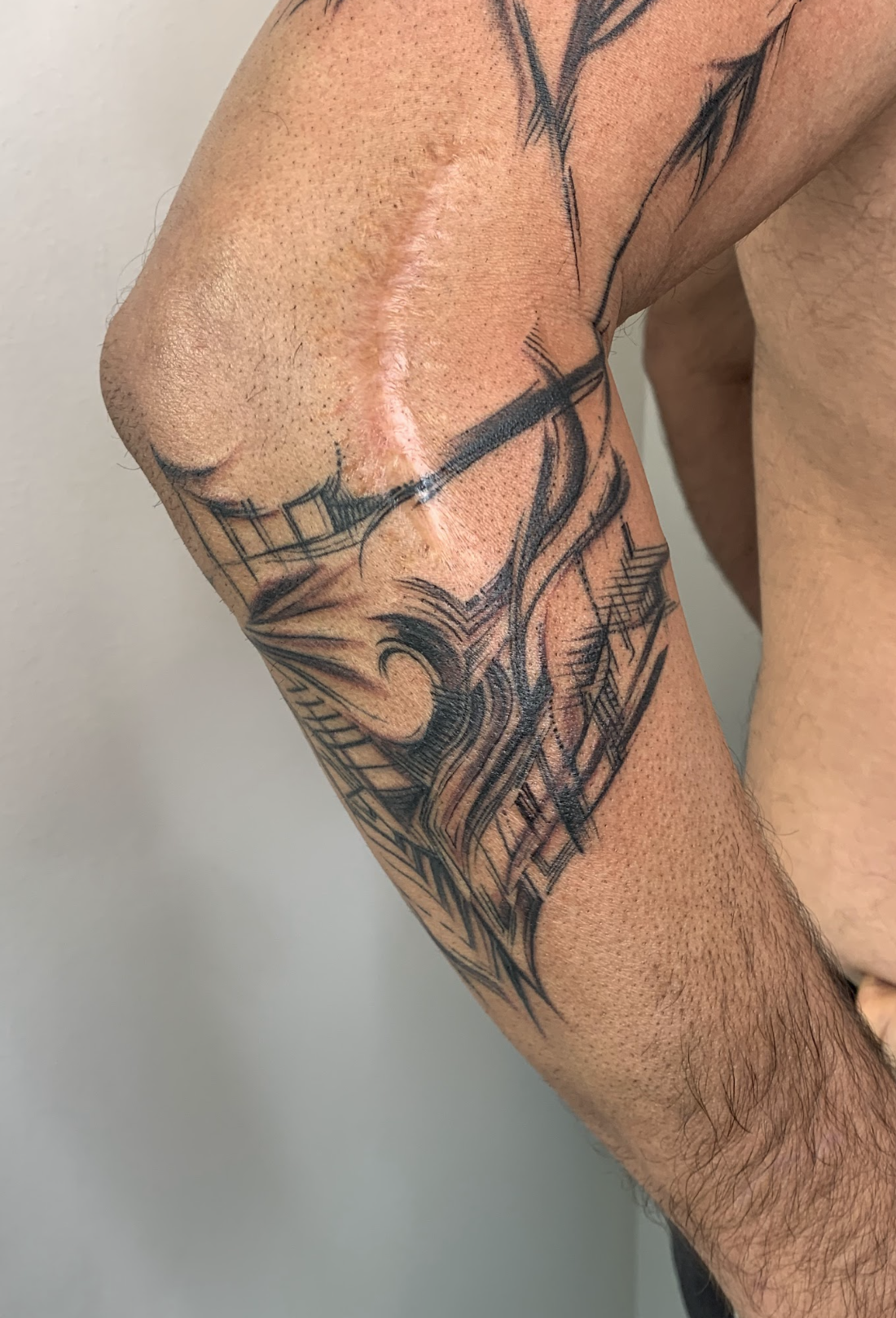 Architectural Scar Integration & Elbow Linework Tattoo by Justine Almaraz