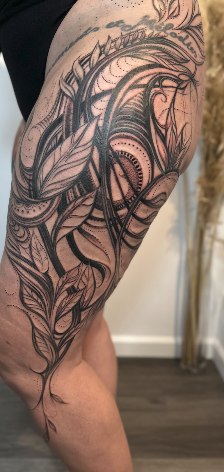 Intricate Fine-Line Botanical Flourish & Stippled Eye Motif Tattoo by Justine Almaraz