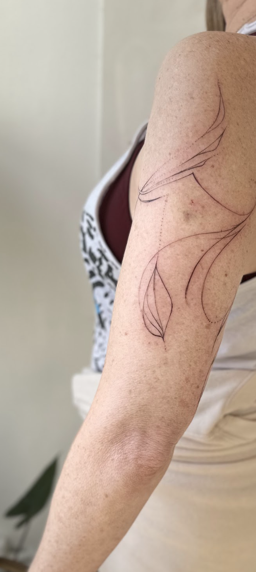 Intuitive Flowing Botanical Tricep & Upper Arm Tattoo by Justine Almaraz