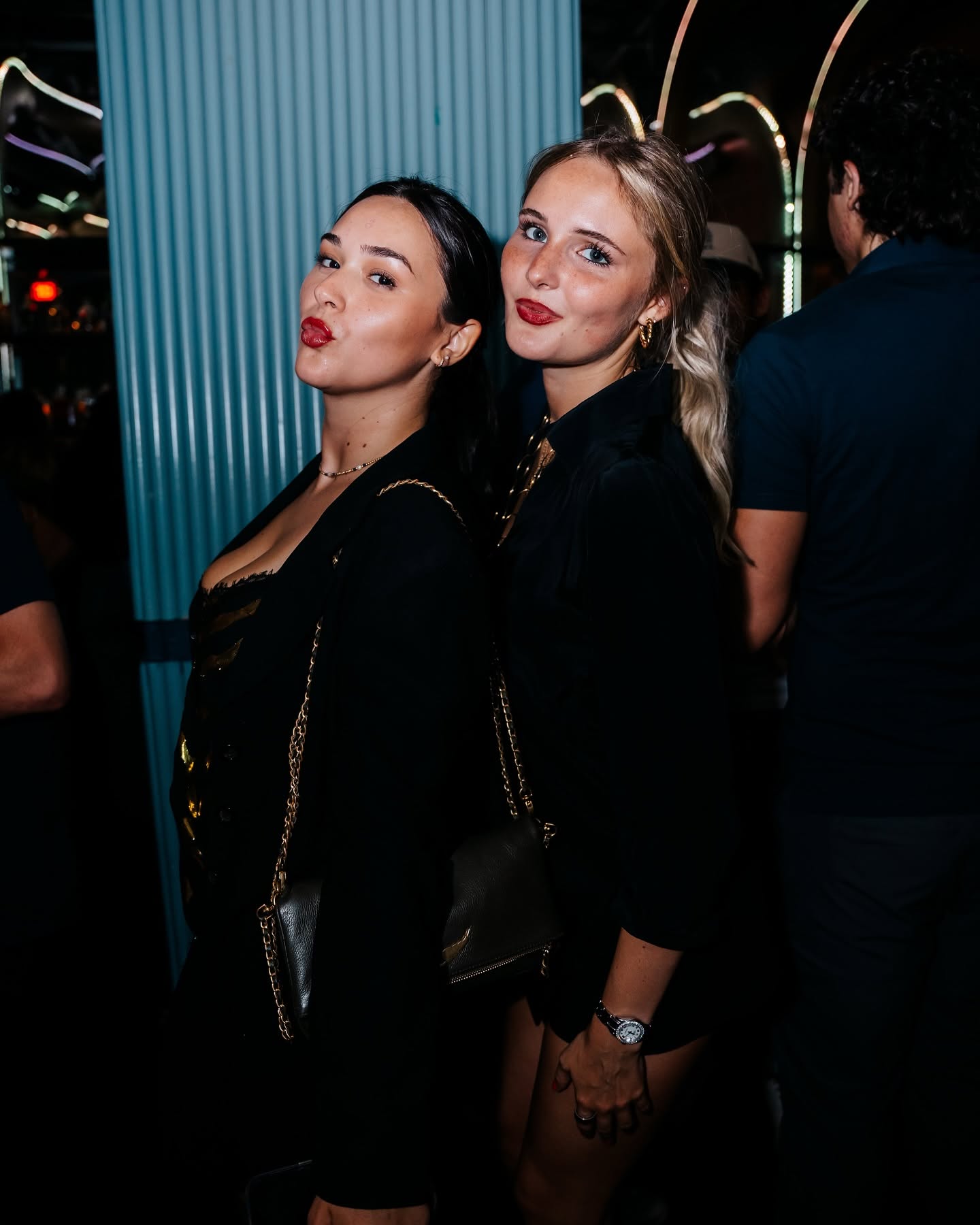 Guests dressed in black nightlife fashion at McQueens