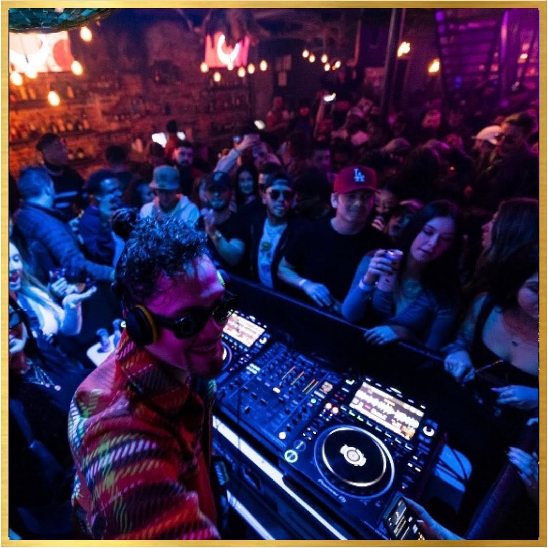 Packed crowd celebrating around the DJ booth at McQueens
