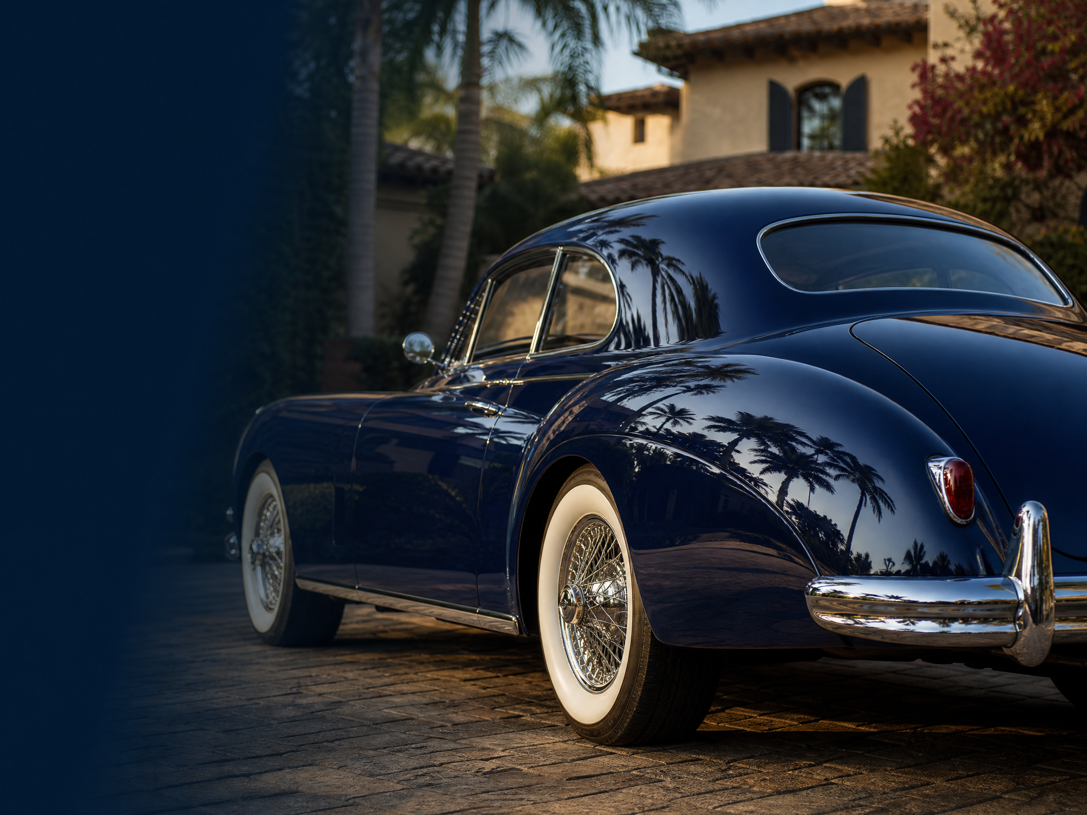 Immaculate navy classic car with mirror-like paint reflection