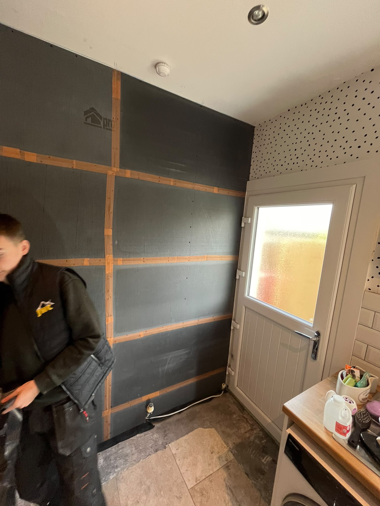 Team member fitting damp proof membrane