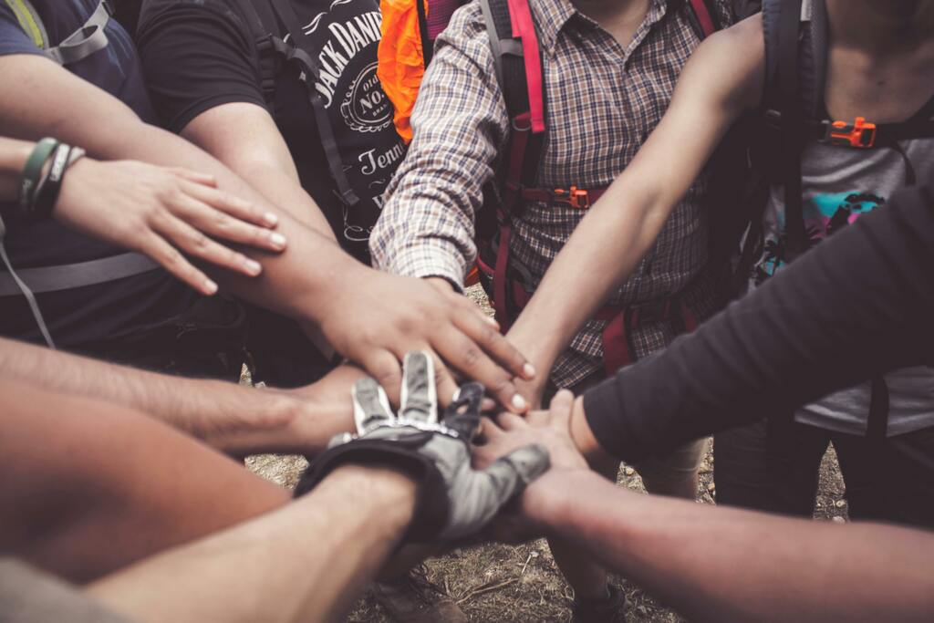 Diverse individuals joining hands in unity