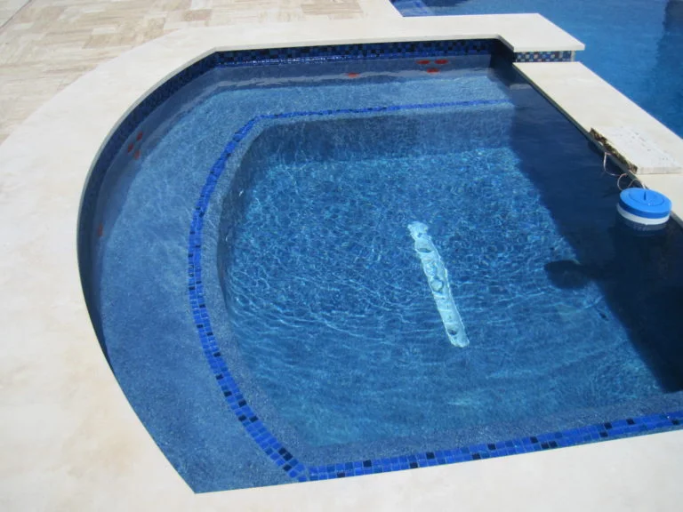Deep Blue Interior Spa with Travertine Coping