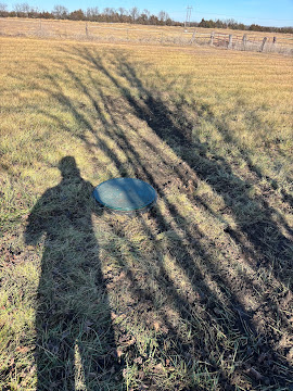 Finished septic lid sitting flush in restored pasture grass