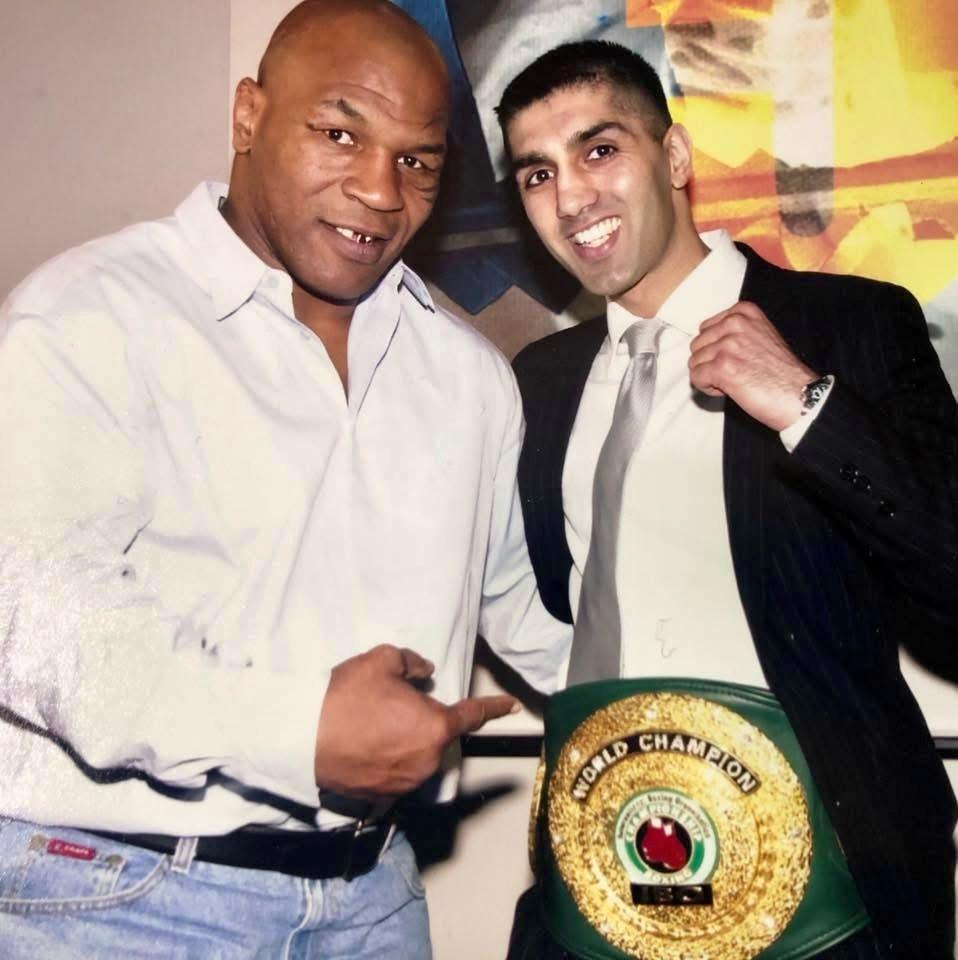 Mike Tyson with Jawaid Khaliq MBE holding his IBO World Championship Belt