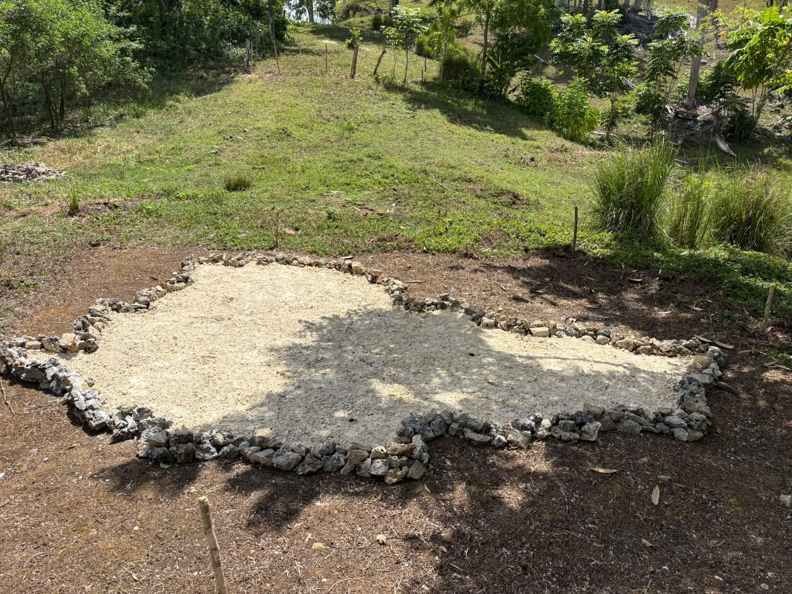 A nation outlined in stone and pale sand at Future Islands Lab
