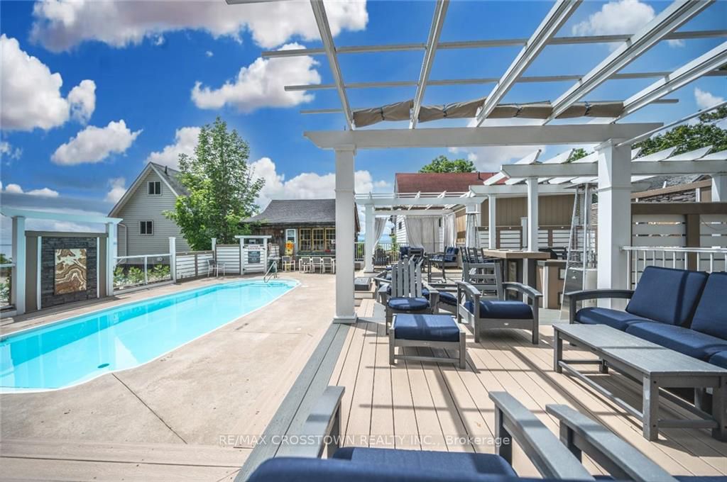 Seasonal saltwater swimming pool with lounge deck, pergola, and outdoor seating