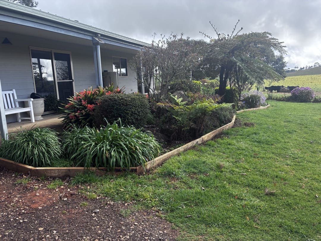 Timber garden edging installed along house perimeter garden bed