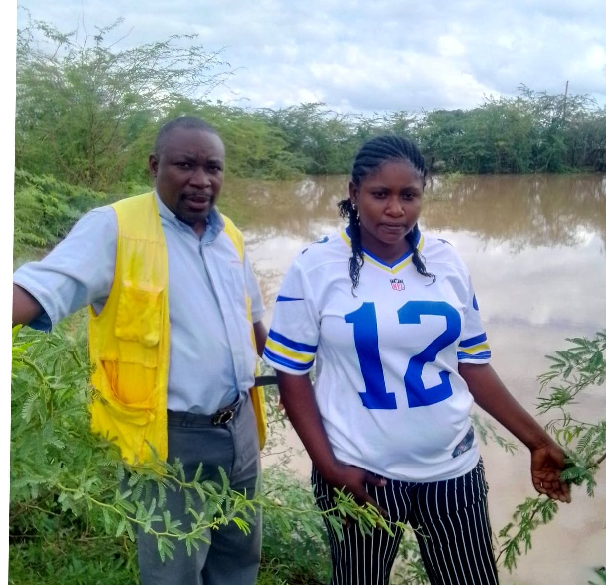 Chairperson Ivona Ndayizeye and MEAL Officer Joseph Nzigimana assessing rainwater accumulation in Kakuma