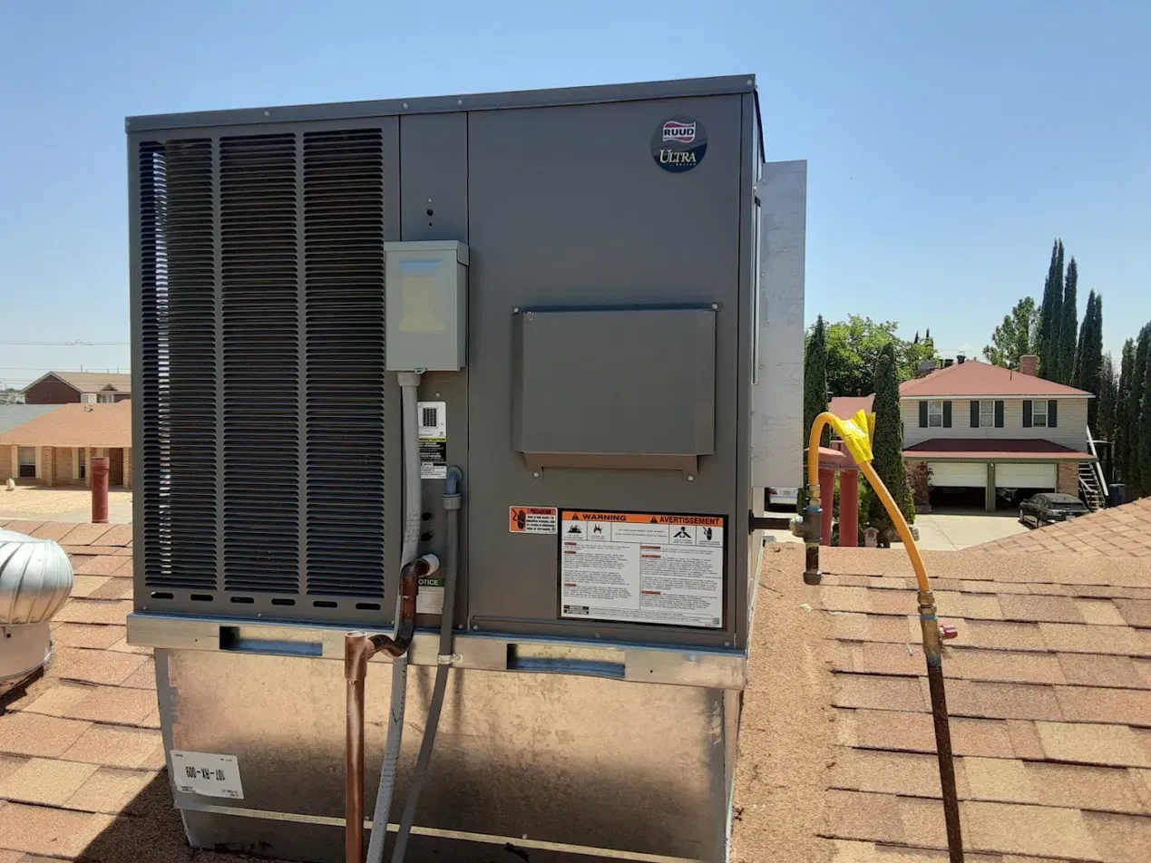 New RUUD Ultra package air conditioning unit installed on residential roof in El Paso