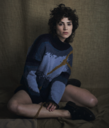 Hand-knitted garments laid out for finishing in natural light