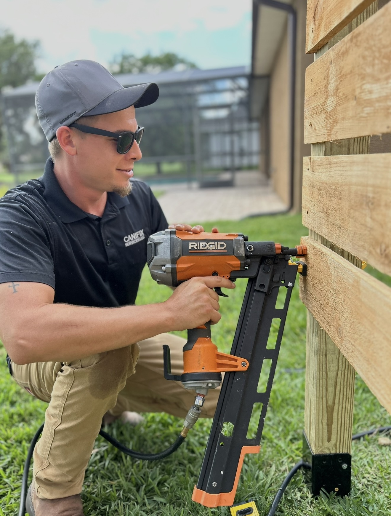 Lothar Schafer operating a nail gun on site in CANIFIX work polo