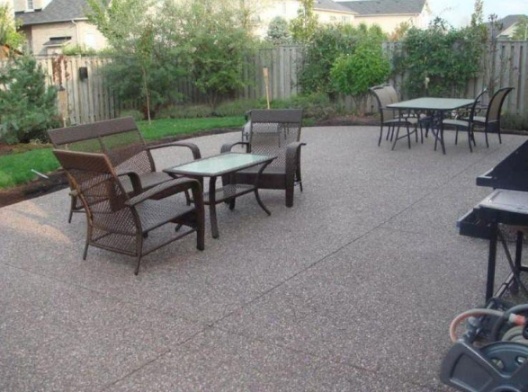 Finished concrete patio with outdoor living space and shaded seating, installed by a concrete contractor in Casas Adobes, AZ