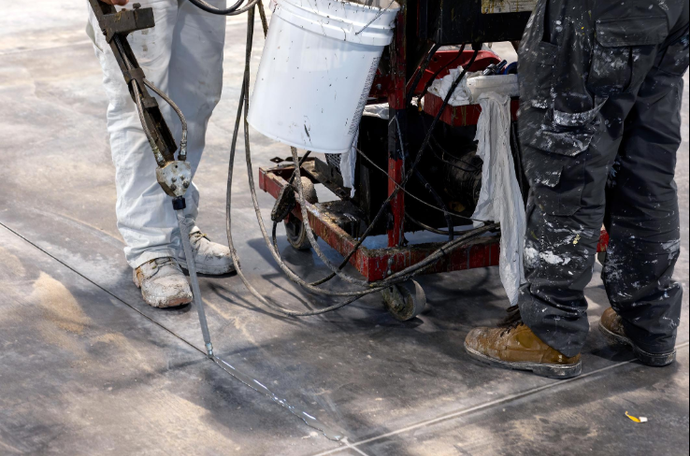 Cracked and spalled concrete surface being patched and restored with repair material by a concrete contractor in Casas Adobes, AZ