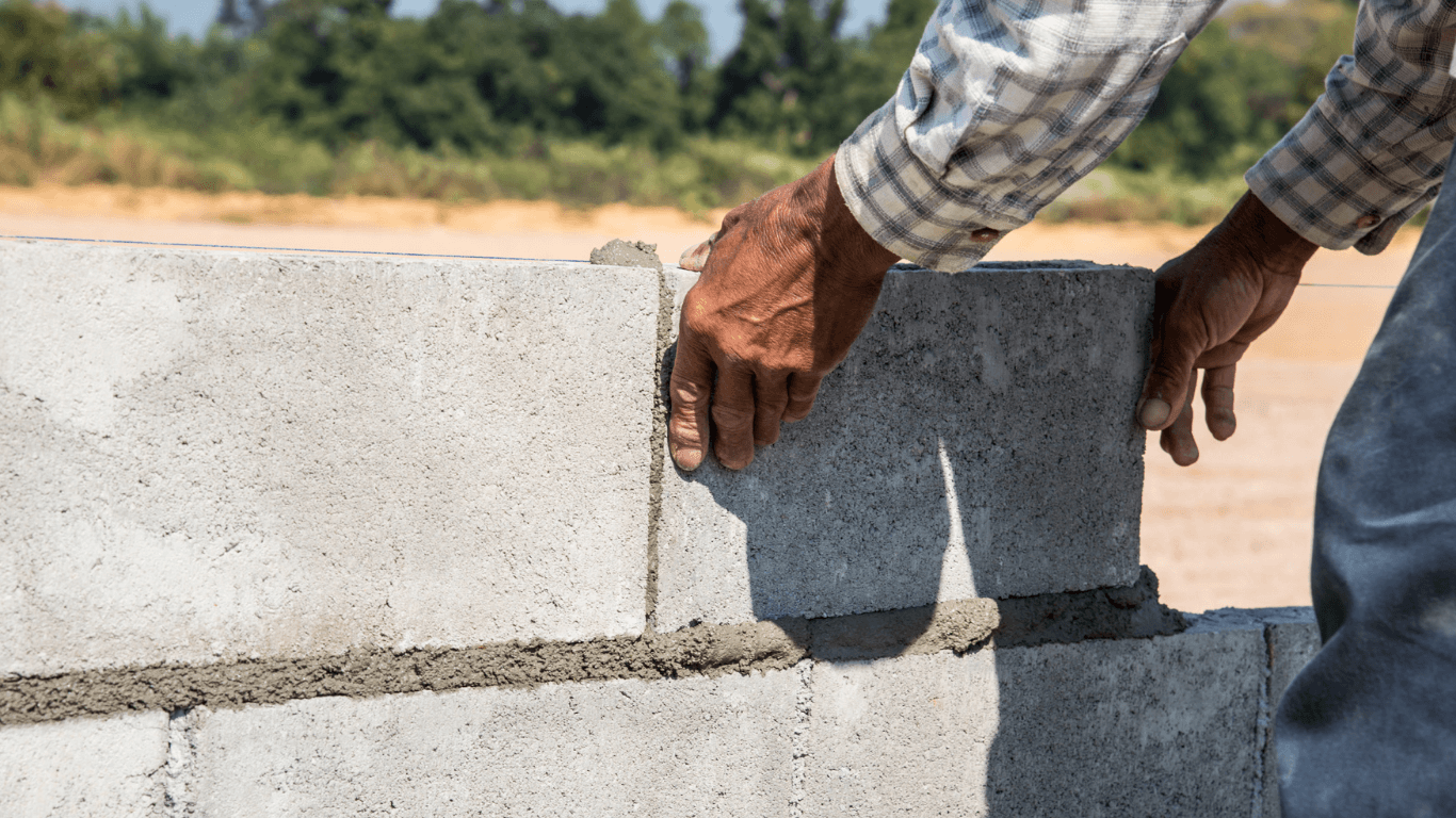 Concrete contractor building a block retaining wall during a project in Casas Adobes, AZ