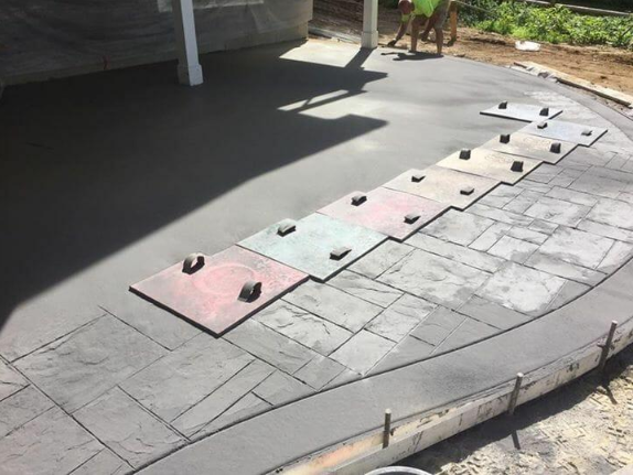 Decorative stamped concrete surface with stone-look texture pattern, installed by a concrete contractor in Casas Adobes, AZ